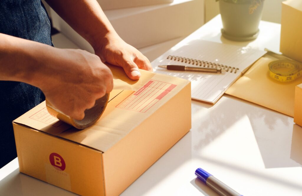 Employees are preparing products to be packed into boxes. for delivery Prepare packages for mailing